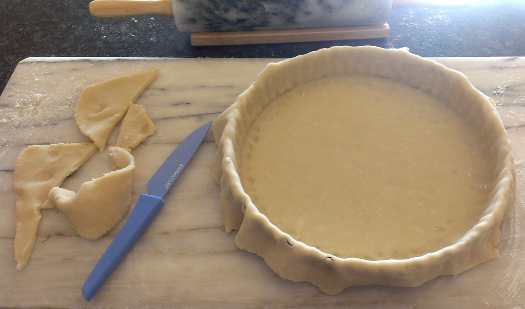 Gently manoeuvre the pastry into place without breaking or stretching. 