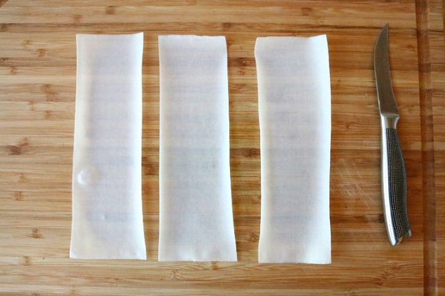 Cut the Spring Roll wrappers into 3 strips. 