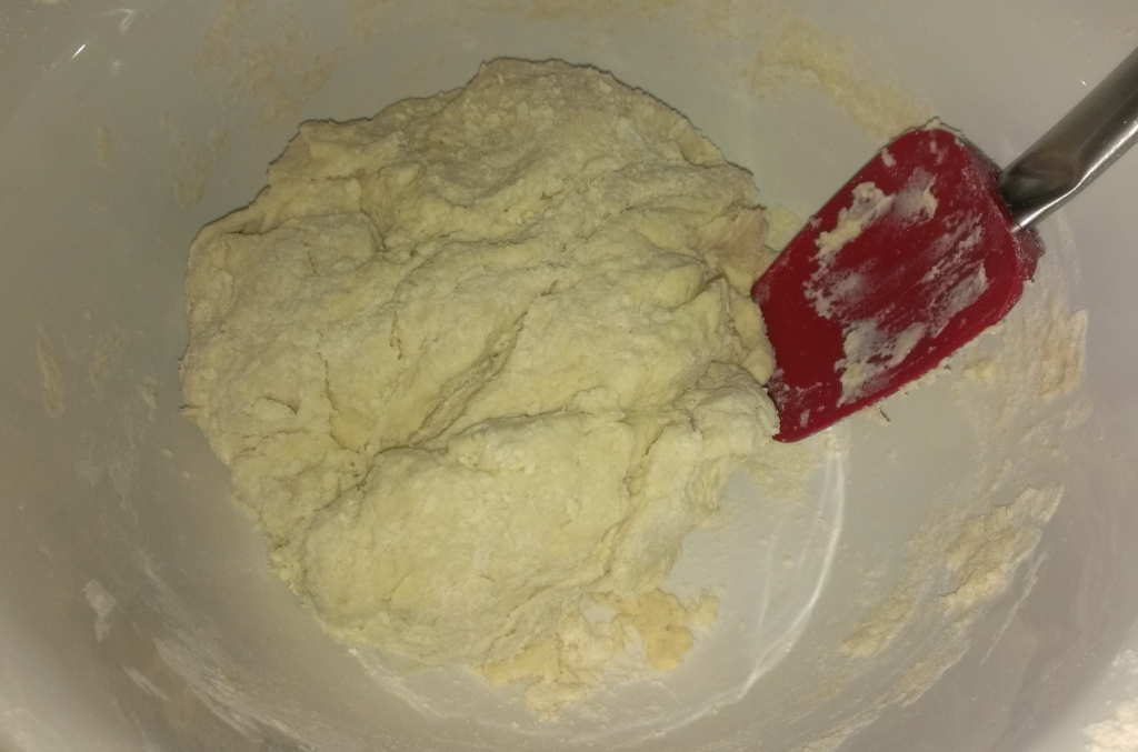 Mix quickly until the dough comes together into a thick lumpy ball 
