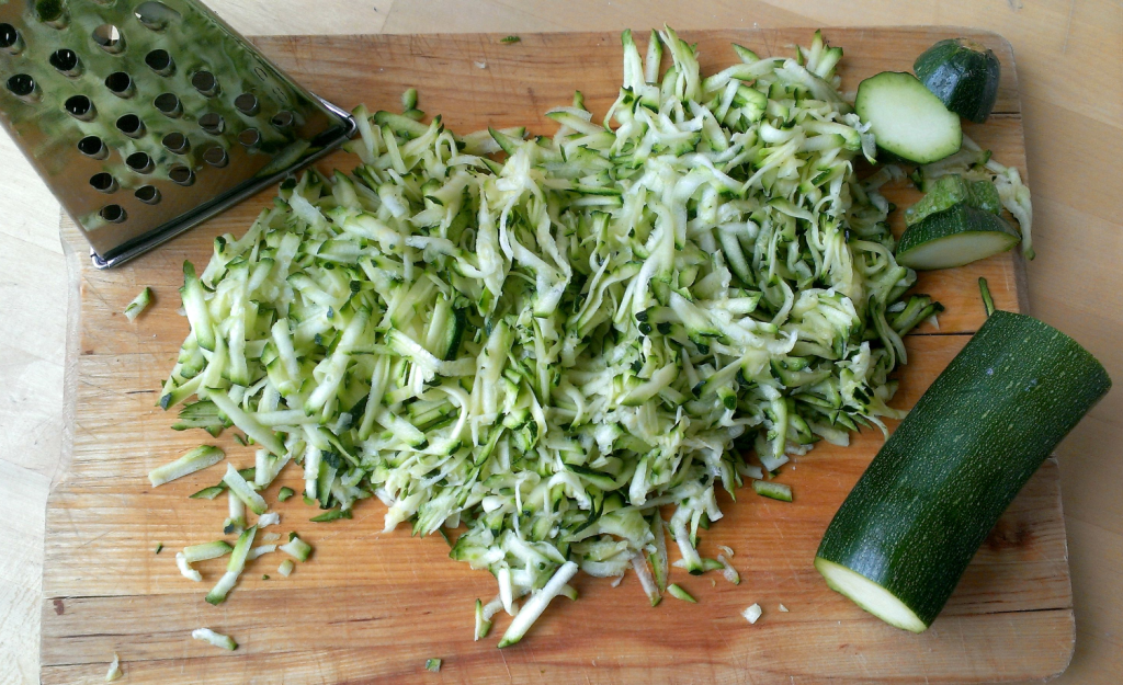 Grate the courgette using the large holes in the grater. 