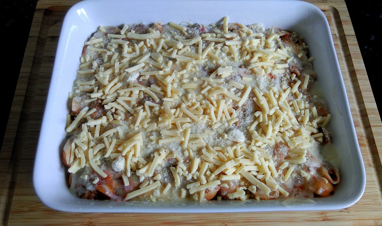 Top the pasta with white sauce & cheese 
