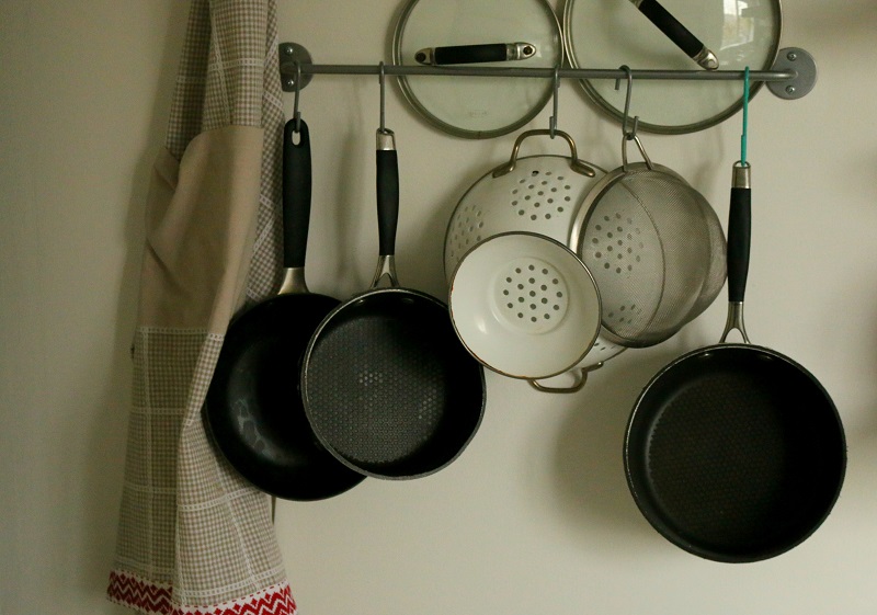 Add tension rods & hooks to free up cupboard space and have a space to hang aprons, towels, oven gloves etc. 